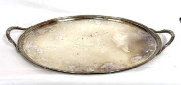 A Victorian twin handled silver plated serving tray, the centre with an engraved crest, 60cm wide