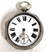 A silver pocket watch with white enamel dial and contrasting black Roman numeral hour markers,