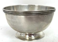 A George V silver pedestal bowl of plain polished form, applied reeded border to a spreading collett