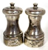 Two Elizabeth II silver cased capston pepper mills, London 1985/86, makers mark for J A Campbell,