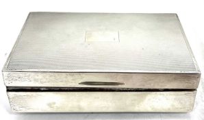 A hallmarked silver cigarette box of rectangular form, the hinged lid with engine turned