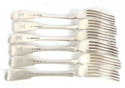 A set of six George IV silver fiddle pattern table forks each engraved with a crest on the