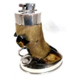 A Vintage Ronson table lighter mounted as a deers foot to an oval shaped loaded silver plate base,