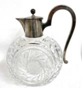 An antique German 800 marked silver mounted glass ewer/claret jug, the body with a cut glass swirl