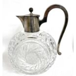 An antique German 800 marked silver mounted glass ewer/claret jug, the body with a cut glass swirl