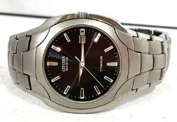 A Citizen Ecodrive titanium and stainless steel watch, the watch has a gun metal colour dial with