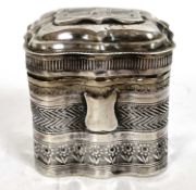 A continental white metal pill box chased and engraved decoration around a shield cartouche, 4 x 3 x