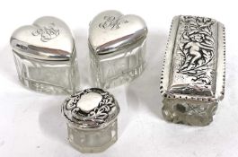 Mixed Lot: A pair of glass heart shaped jars with hallmarked silver pull off lids, engraved with