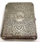 A Victorian card case elaborately engraved around a central monogram, hallmarked London 1877, makers