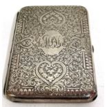 A Victorian card case elaborately engraved around a central monogram, hallmarked London 1877, makers