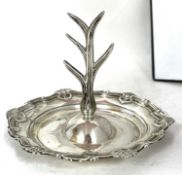An Edwardian silver ring tree having a central five branch tree, (for rings), attached to a round