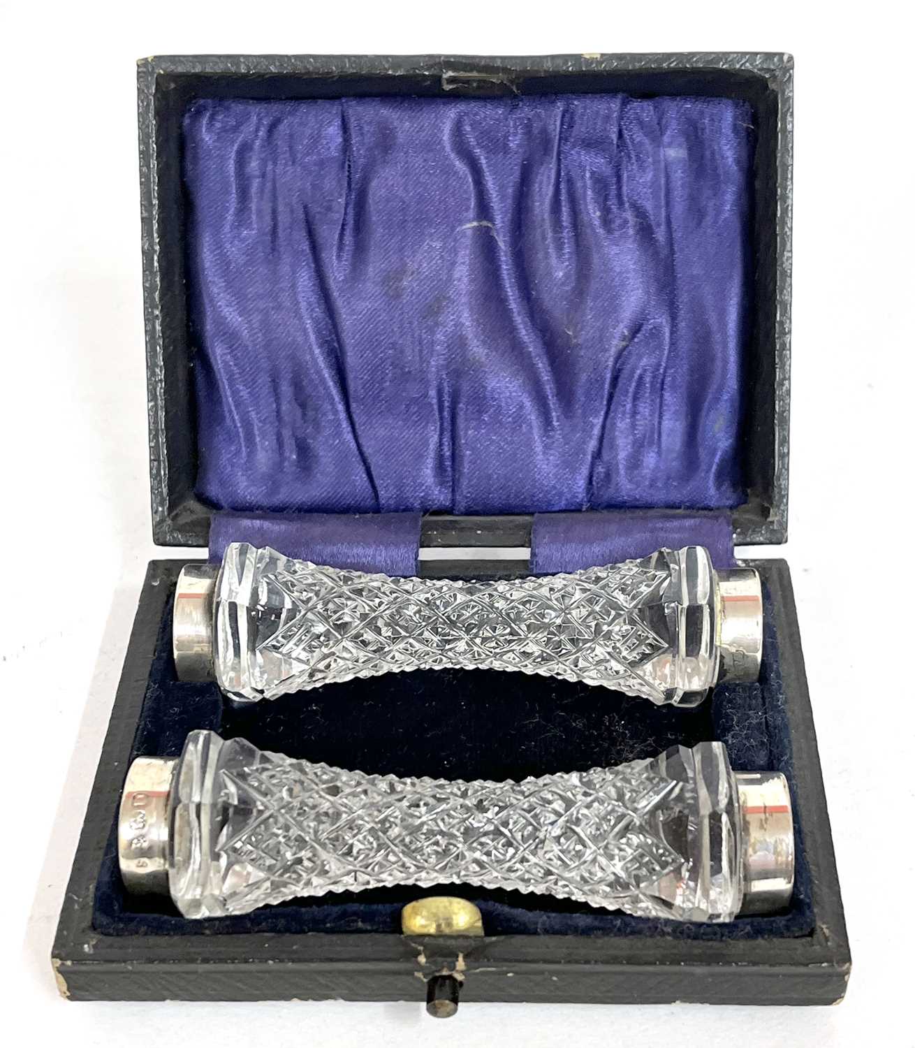 A pair of Edwardian cut glass knife rests with silver collars at each end, hallmarked for Birmingham