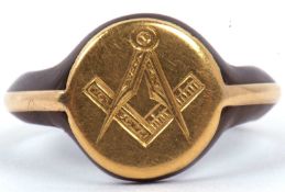 An antique Masonic gold and tortoiseshell ring, circa 1900, the round panel engraved with a set