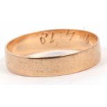 Yellow metal wedding ring of plain polished design engraved inside with a D.B 2.4.18, tests 9ct