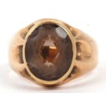 Antique smokey quartz ring, the oval faceted quartz bezel set and raised between a plain polished