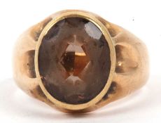 Antique smokey quartz ring, the oval faceted quartz bezel set and raised between a plain polished