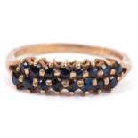 9ct gold and sapphire ring, a design with two rows of small round cut faceted sapphires raised