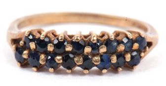 9ct gold and sapphire ring, a design with two rows of small round cut faceted sapphires raised