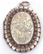 Hallmarked silver large oval locket, the centre chased and engraved with scrolls, 50 x 40 mm,