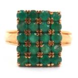 Emerald tablet ring, the rectangular panel is 16 x 12 mm, set with twenty small round cut emeralds