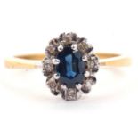 18ct gold sapphire and diamond cluster ring, the oval cut sapphire raised above a small diamond