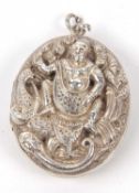 Indian white metal large hinged locket of oval form, the front decorated with a religious scene