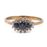 9ct gold sapphire and diamond ring featuring three dark graduated sapphires within a small single