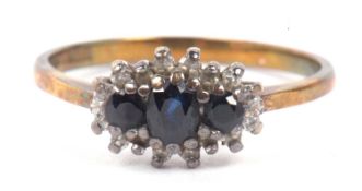 9ct gold sapphire and diamond ring featuring three dark graduated sapphires within a small single