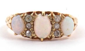 Antique 18ct gold opal and diamond ring featuring three graduated oval cabochon cut opals,