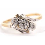 An 18ct and platinum diamond ring, the three illusion set diamonds, in a crossover mount, with plain