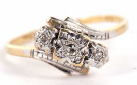 An 18ct and platinum diamond ring, the three illusion set diamonds, in a crossover mount, with plain