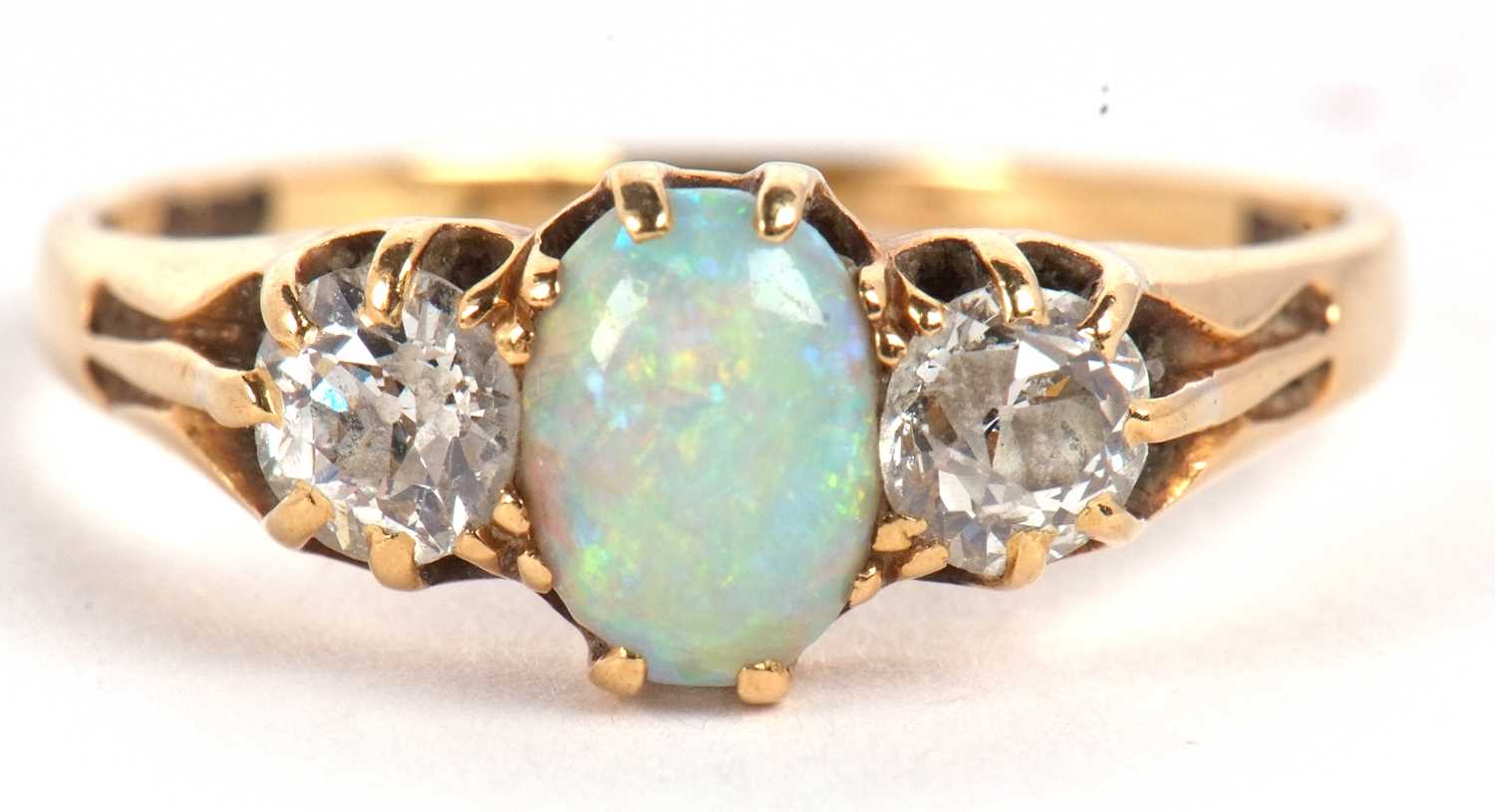 An opal and diamond ring, the oval opal set to either side with an old round brilliant cut - Image 2 of 10