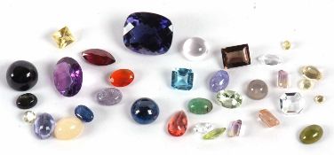 A quantity of loose gemstones to include a round kyanite cabochon, a mixed cut iolite, amethyst, a