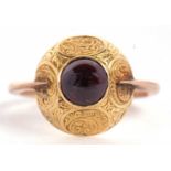 A late 19th century garnet ring, the round garnet cabochon, collet mounted within a broad domed