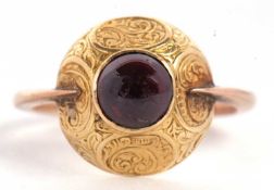 A late 19th century garnet ring, the round garnet cabochon, collet mounted within a broad domed