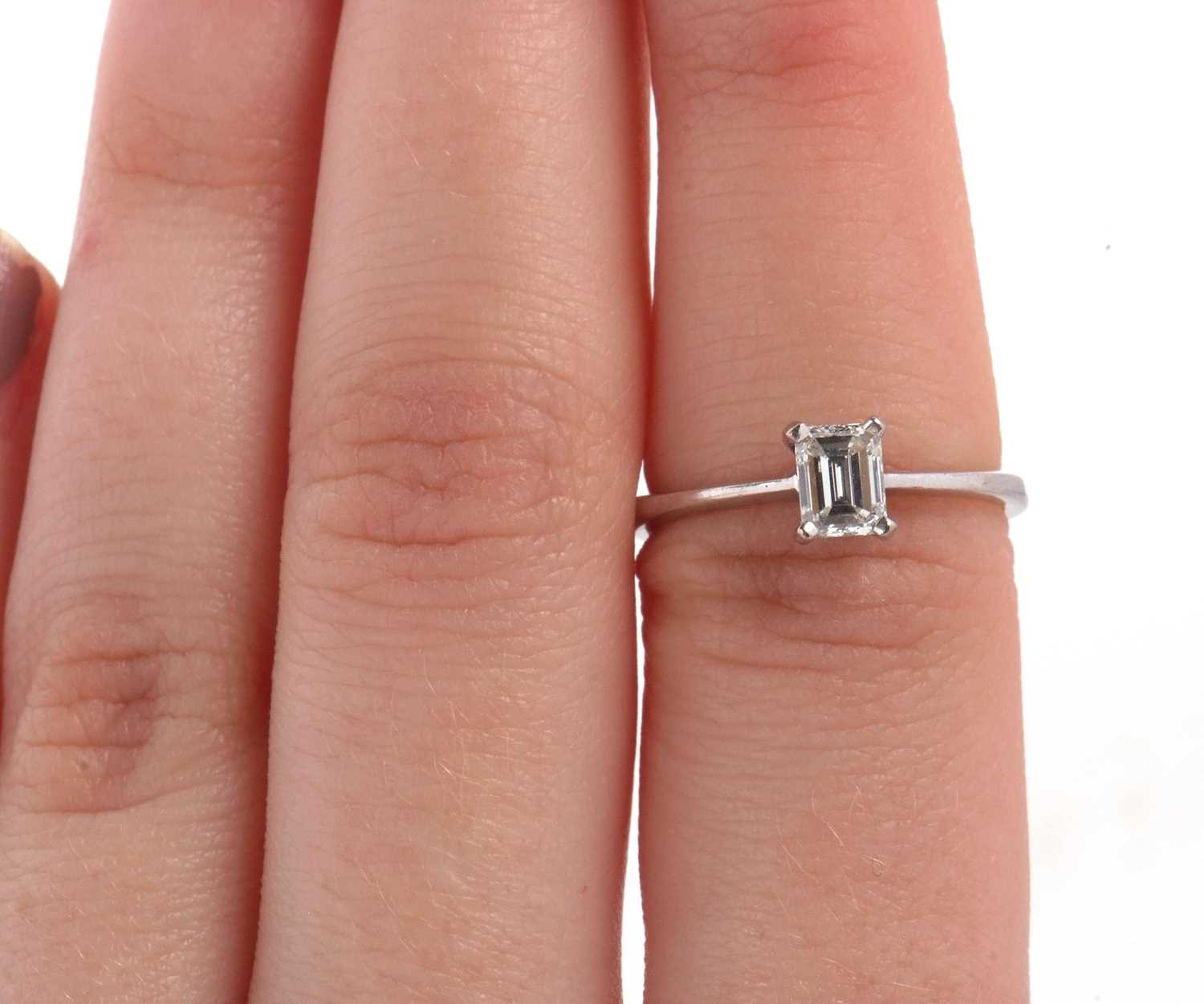 An 18ct white gold diamond solitaire ring, the 0.51ct emerald cut diamond, in a four claw setting to - Image 9 of 9