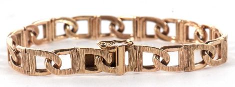 A 9ct fancy link bracelet, the textured D-links with concealed clasp, stamped 375 and hallmarked