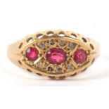 An 18ct ruby and diamond ring, the oval and round rubies set within a marquise shaped plaque set