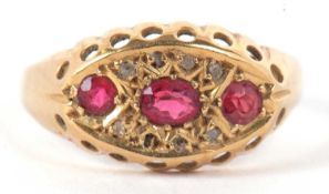 An 18ct ruby and diamond ring, the oval and round rubies set within a marquise shaped plaque set