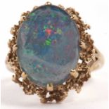 A 9ct opal triplet ring, the oval opal triplet cabochon, claw mounted with textured metal