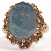 A 9ct opal triplet ring, the oval opal triplet cabochon, claw mounted with textured metal