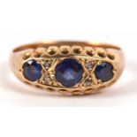 An 18ct sapphire and diamond ring, the three round sapphires set with diamond highlights, with