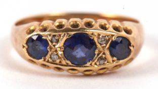 An 18ct sapphire and diamond ring, the three round sapphires set with diamond highlights, with