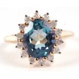 A 9ct 'Mystic topaz' and diamond cluster ring, the oval 'Mystic topaz' approx.12.5 x 9.9 x 6.4mm,