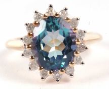 A 9ct 'Mystic topaz' and diamond cluster ring, the oval 'Mystic topaz' approx.12.5 x 9.9 x 6.4mm,