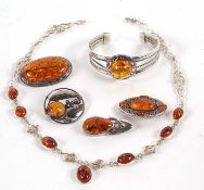 A quantity of Celtic style and other amber jewellery to include an oval amber cabochon and