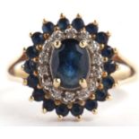 An 18ct sapphire and diamond cluster ring, the central oval sapphire surrounded by small round