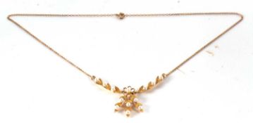 A 9ct cultured pearl necklace, the central rosette set with a cultured pearl, suspending three
