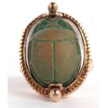 A 9ct scarab ring, the oval rotating scarab, set within a collet mount with rope twist border,