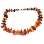 Amber nugget bead necklace, largest approx. 3.5cm long, with silver clasp, 66cm long, 120g gross